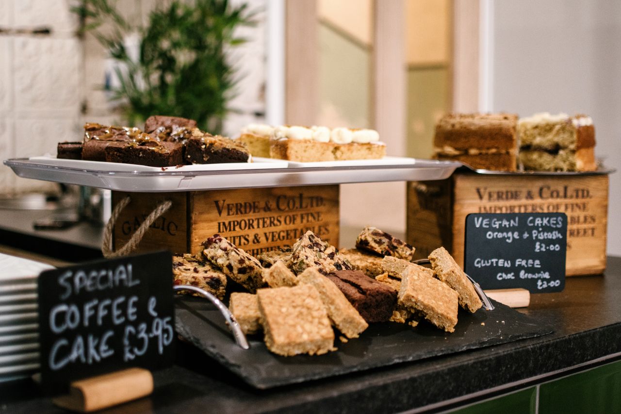 about-02 Assortment of vegan and gluten-free cakes on display at a cafe. Perfect for indulgence.