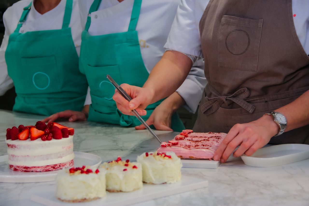 The Art of Drawing Readers In: Your attractive post title goes here Chefs in stylish aprons expertly craft strawberry-topped pastries in a modern kitchen.